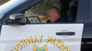 California Highway Patrol officer Andrew Barclay runs a commuter's drivers' license number and information