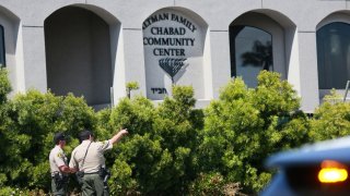 San Diego Sheriff deputies look over the Chabad of Poway Synagogue.