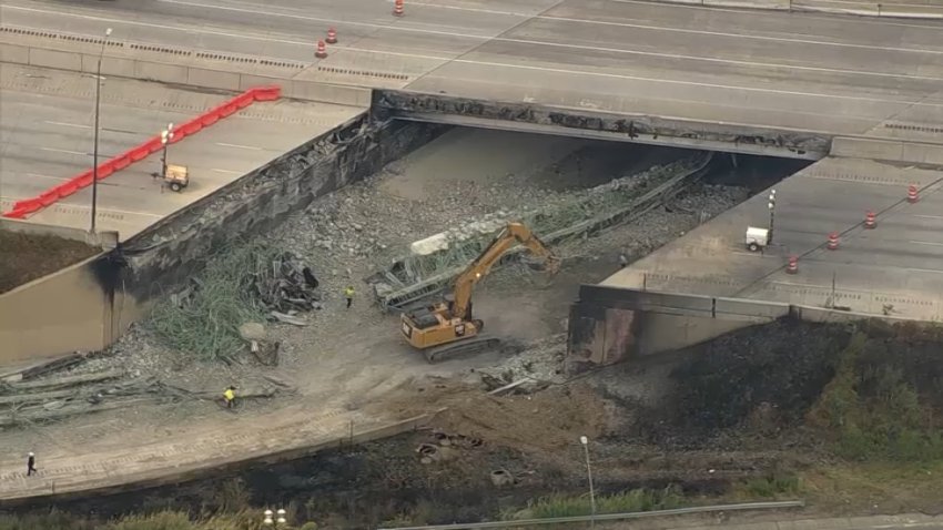 Crews work to remove rubble from the site of the collapse if I-95 in Northeast Philadelphia on Monday.