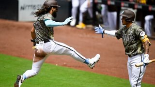 SAN DIEGO, CA – JUNE 18: Fernando Tatis Jr. #23 of the San Diego Padres, left, is congratulated by Manny Machado #13 after scoring during the third inning against the Tampa Bay Rays on June 18, 2023 at Petco Park in San Diego, California. (Photo by Denis Poroy/Getty Images)