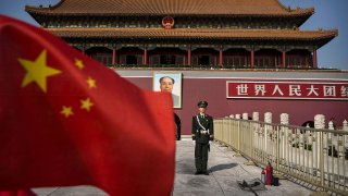 A Chinese soldier stands guard in front of Tiananmen Gate outside the Forbidden City on October 27, 2014 in Beijing, China.