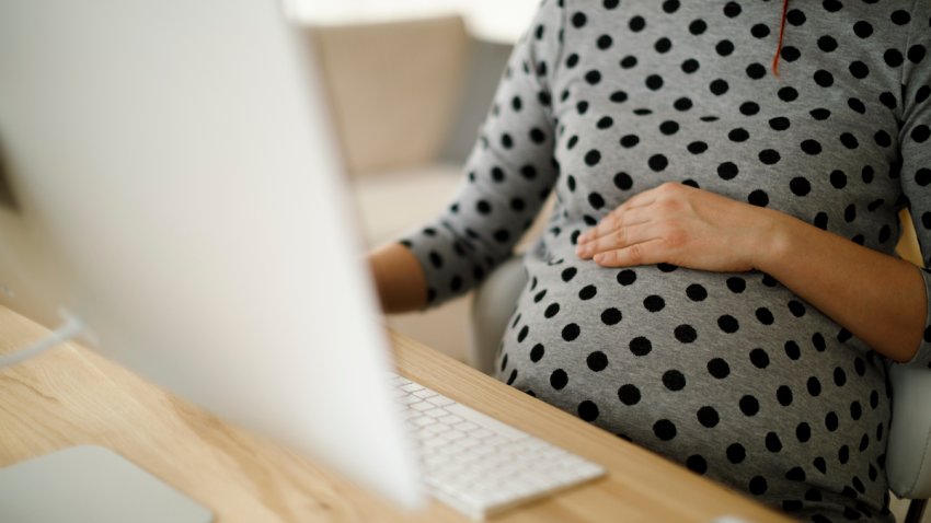 Pregnant woman working from home office