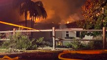 Firefighters respond to a fire at a home in Escondido on Thursday, June 15, 2023.