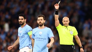 Referee Szymon Marciniak shows a yellow card to Ilkay Gundogan of Manchester City during the UEFA Champions League semi-final second leg match between Manchester City FC and Real Madrid at Etihad Stadium on May 17, 2023 in Manchester, United Kingdom.