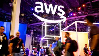 Attendees walk through an expo hall during Amazon Web Services’ Reinvent conference at the Venetian in Las Vegas on Nov. 29, 2022.