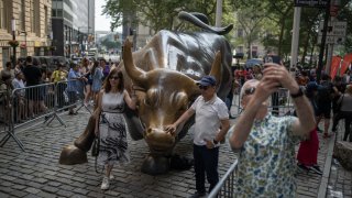 Visitors around the ‘Charging Bull’ statue near the New York Stock Exchange (NYSE) in New York, US, on Thursday, June 29, 2023.