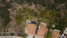 This aerial photo, taken in May of 2023, shows the family's home at the edge of the Los Peñasquitos Canyon Preserve. There has been some regrowth since the brush was cleared two years prior.