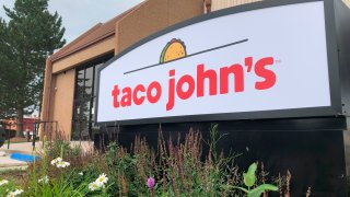 FILE – A sign stands outside the corporate headquarters of Cheyenne-based Taco John’s, Aug. 1, 2019, in Cheyenne, Wyo.