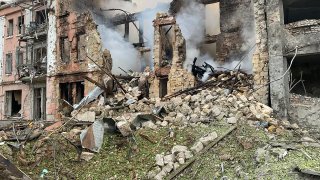 In this photo provided by the National Police of Ukraine, smoke rises from a building destroyed by a Russian attack in Mykolaiv, Ukraine, Thursday, July 20, 2023.