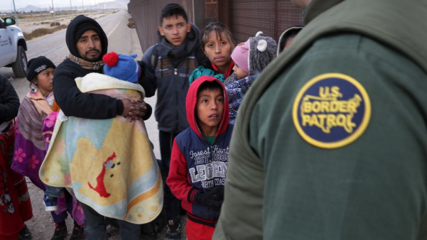 A U.S. Border Patrol agent speaks with Central American immigrants at the U.S.-Mexico border fence on February 01, 2019 in El Paso, Texas.