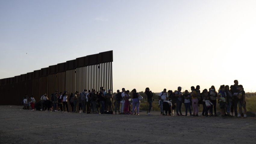 Migrants seeking asylum wait to be processed by U.S. Border Patrol agents after crossing the Mexico and U.S. border in Yuma, Arizona, U.S. on Tuesday, May 3, 2022.