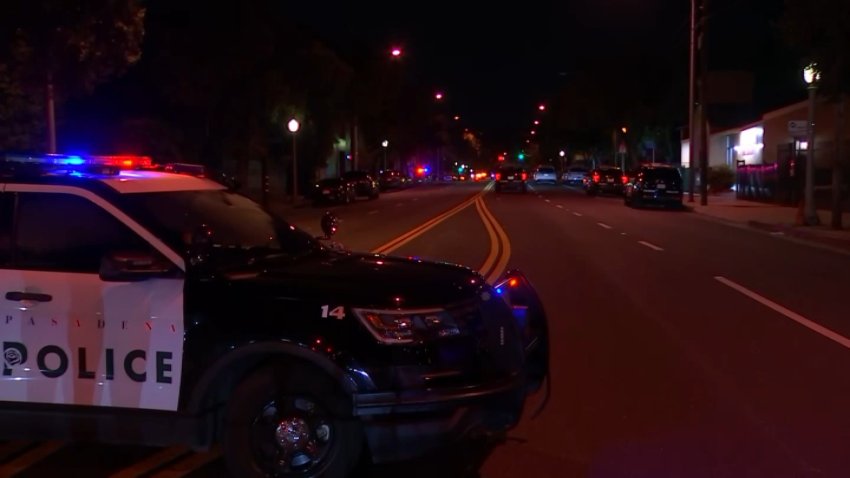 A Pasadena Police Department SUV parked in the middle of a road.