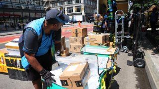 Amazon workers sort packages for delivery in New York, July 12, 2022.