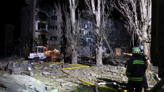 Rescuers at work near a damaged residential building after Russian missile strikes in Pokrovsk, Donetsk.