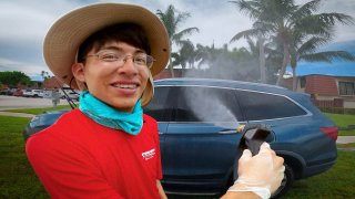 Randy Roblero cleaning a customer’s car.