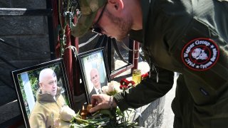 A member of private mercenary group Wagner pays tribute to Yevgeny Prigozhin and Dmitry Utkin following their apparent deaths in a plane crash on Aug. 23, 2023.