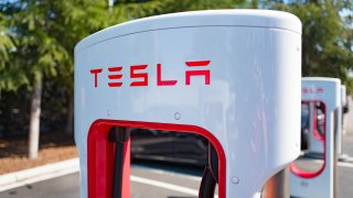 Charger with Tesla logo at a Supercharger rapid battery charging station for the electric vehicle company Tesla Motors, in the Silicon Valley town of Mountain View, California, Aug. 24, 2016.