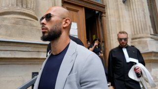 Andrew Tate leaves the Court of Appeal building followed by his lawyer Eugen Vidineac in Bucharest, Romania, Tuesday, Aug. 1, 2023. Andrew Tate, the divisive social media personality who is charged in Romania with rape, human trafficking, and forming a criminal gang to sexually exploit women, appealed against a court’s decision to keep him and his brother under house arrest for the duration of his trial.
