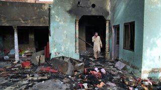 A Christian man looks at a home vandalized by an angry Muslim mob in Jaranwala in the Faisalabad district, Pakistan, Thursday, Aug. 17, 2023. Police arrested more than 100 Muslims in overnight raids from an area in eastern Pakistan where a Muslim mob angered over the alleged desecration of the Quran by a Christian man attacked churches and homes of minority Christians, prompting authorities to summon troops to restore order, officials said Thursday.