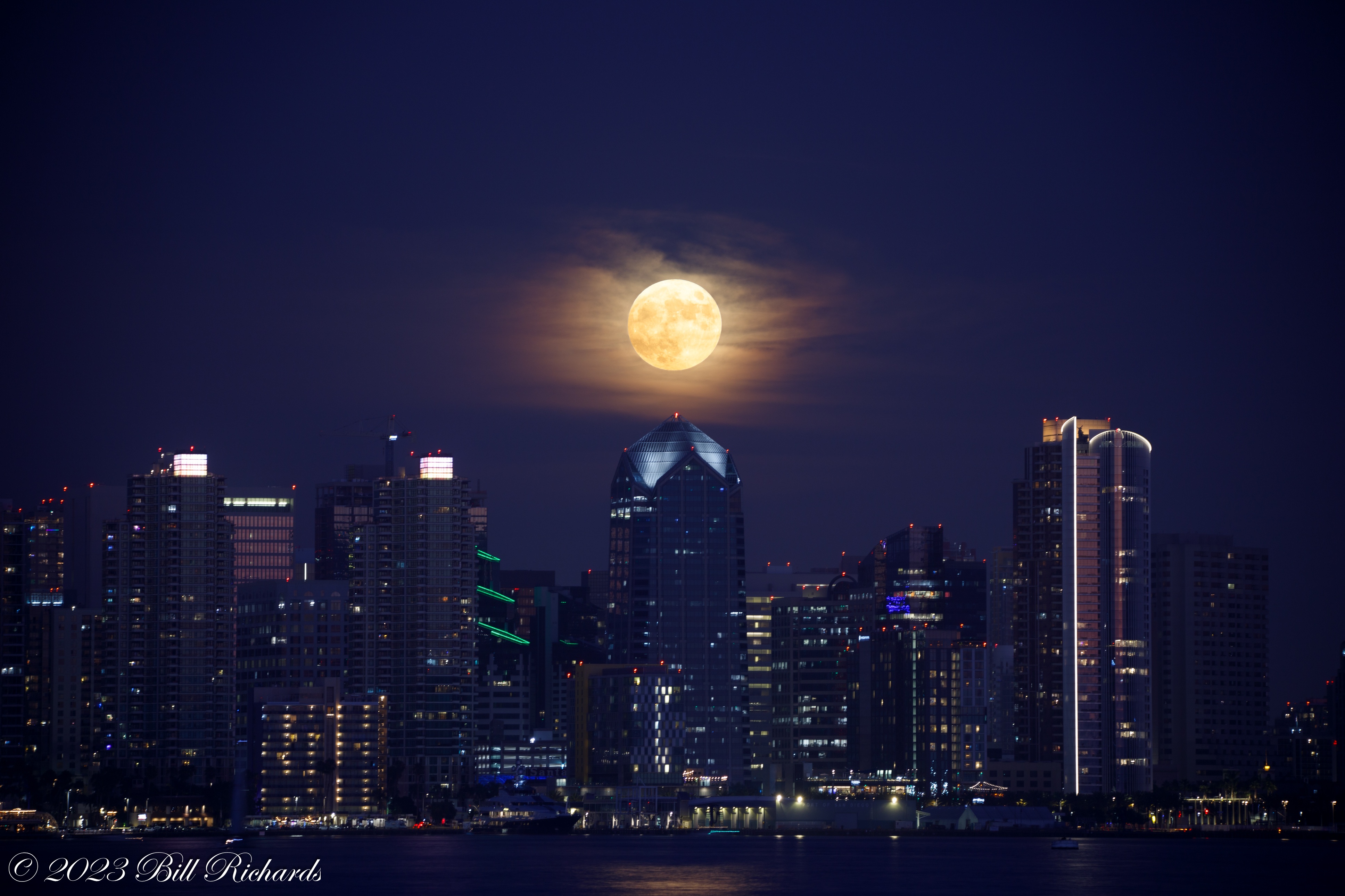 The San Diego skyline lights up under a bright supermoon in this image by Bill Richards.