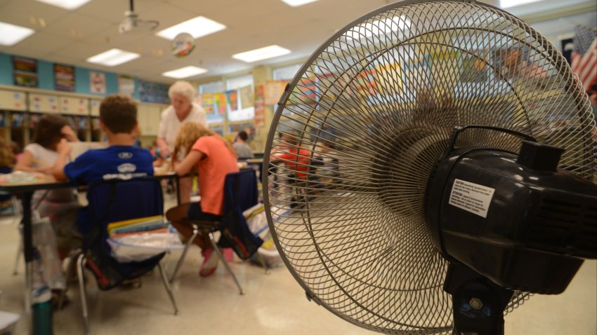 Hot Schools A fan attempts to cool the classroom of  East Earl Elementary fourth-grade teacher Barb Bigler as she helps students with their work. The school dismissed early Thursday and will also on  Friday because of the heat.  Photo by Bill Uhrich  9/8/2016 (Photo By MediaNews Group/Reading Eagle via Getty Images)