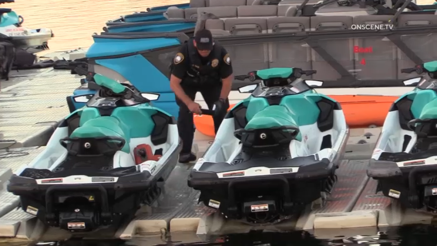 A San Diego harbor police officer inspects a jet ski after a crash on San Diego Bay left a woman with serious injuries on Aug. 28, 2023.