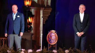 Disney Co. executives CEO Bob Chapek, left, and Bob Iger, executive chairman, deliver remarks at Cinderella Castle at the Magic Kingdom during ceremonies marking the 50th anniversary of Walt Disney World, in Lake Buena Vista, Florida, Sept. 30, 2021.