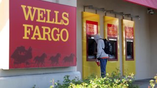 A customer uses an ATM at a Wells Fargo Bank in San Bruno, California, on April 14, 2023.