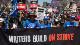 Striking members of the Writers Guild of America and supporters march toward the La Brea Tar Pits in Los Angeles, June 21, 2023.