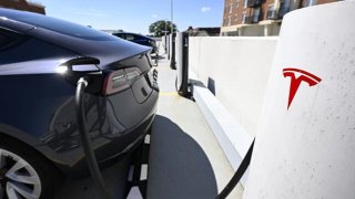 The Tesla logo is seen on a charging station in Virginia, Aug. 16, 2023.