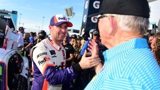 Denny Hamlin, driver of the No. 11 FedEx Ground Toyota, is congratulated in Victory Lane by team owner Joe Gibbs after winning the Monster Energy NASCAR Cup Series Bluegreen Vacations 500 at ISM Raceway on Nov. 10, 2019 in Avondale, Ariz.