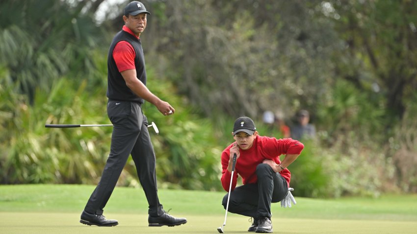 Tiger Woods and his son, Charlie Woods, read the third green during the final round of the PGA TOUR Champions PNC Championship at The Ritz-Carlton Golf Club on Dec. 18, 2022 in Orlando, Fla.