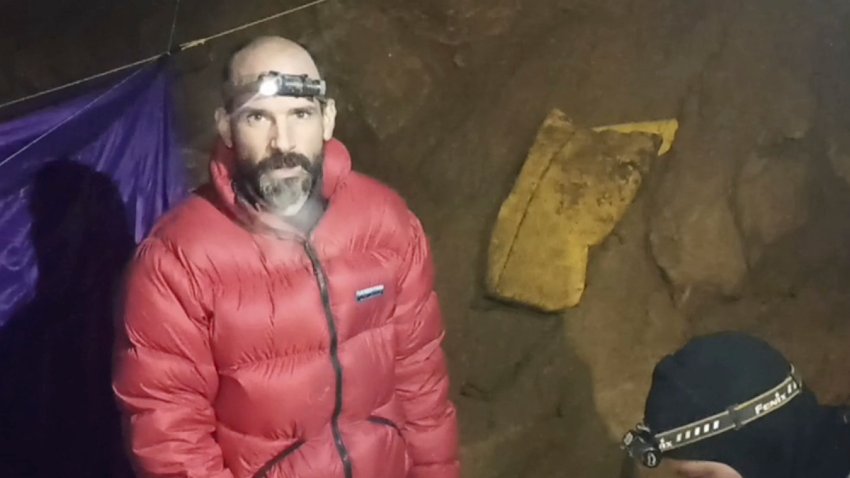 In this screen grab from video, American caver Mark Dickey, 40, talks to camera next to a colleague inside the Morca cave near Anamur, southern Turkey, Thursday, Sept. 7, 2023. Turkish and international cave rescue experts are working to save an American speleologist trapped at a depth of more than 1,000 meters (3,280 feet) in a cave in southern Turkey after he became ill. (Turkish Government Directorate of Communications via AP)