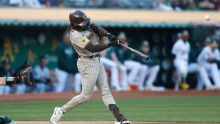 OAKLAND, CALIFORNIA – SEPTEMBER 15: Fernando Tatis Jr. #23 of the San Diego Padres hits a solo home run in the top of the first inning against the Oakland Athletics at RingCentral Coliseum on September 15, 2023 in Oakland, California. Players are wearing #21 in recognition of Roberto Clemente Day. (Photo by Lachlan Cunningham/Getty Images)