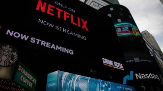 Netflix signage next to the Nasdaq MarketSite in New York, U.S., on Friday, Jan. 21, 2022.