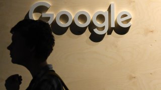 A woman passes the Google logo during the digital society festival re:publica at the Arena Berlin in Berlin, Germany, on June 9, 2022.