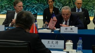 US Senate Majority Leader Chuck Schumer (R) attends a bilateral meeting with Chinese Commerce Minister Wang Wentao (front L) at the Ministry of Commerce in Beijing on October 9, 2023.