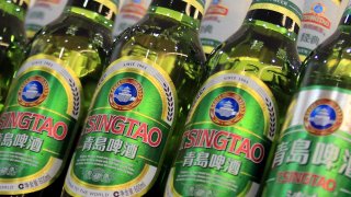 Bottles of Tsingtao beer are placed on shelves at a supermarket in Shanghai.