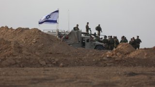 Israeli troops gather near the border with Gaza before entering the Palestinian strip on Oct. 29, 2023.