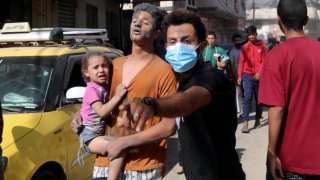 Injured Palestinians are evacuated following Israeli airstrikes