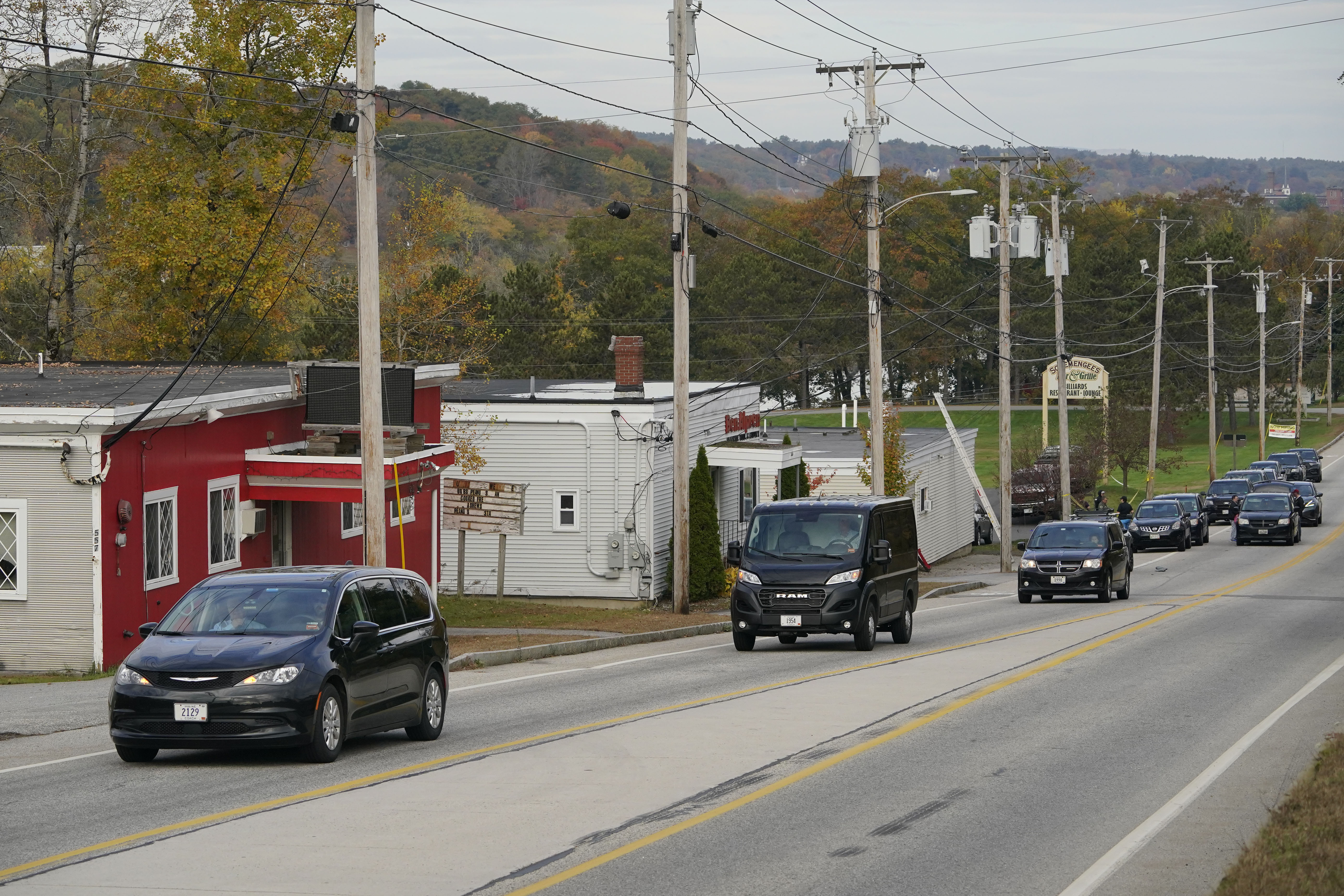 Three vehicles transport bodies from Schemengees Bar and Grille, Thursday, Oct. 26, 2023, in Lewiston, Maine. The restaurant was the site of one of the two mass shootings in Lewiston on Wednesday.