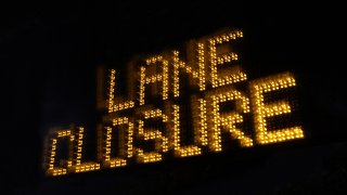"Lane Closure" in amber on black sign