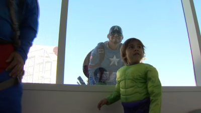 Window-washing superheroes bring smiles to Rady Children's Hospital on Halloween