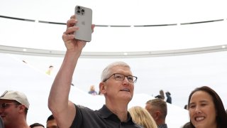 Apple CEO Tim Cook holds up a new iPhone 15 Pro during an Apple event on September 12, 2023 in Cupertino, California.