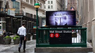 A pedestrian passes a Wall Street subway station near the New York Stock Exchange (NYSE) in New York, U.S., on Monday, June 27, 2022. Money managers betting on a sustained global rebound will be left sorely disappointed in the second half of this crushing year as a protracted bear market looms, even if inflation cools. Photographer: Michael Nagle/Bloomberg via Getty Images