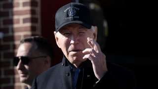 US President Joe Biden crosses his fingers while responding to a question about the release of Hamas hostages after a visit to the Nantucket Fire Department on Thanksgiving November 23, 2023 in Nantucket, Massachusetts.