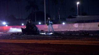 A California Highway Patrol officer investigates a fatal collision in the southbound lanes of Interstate 5 near Palomar St. in Chula Vista, CA on November 27, 2023.
