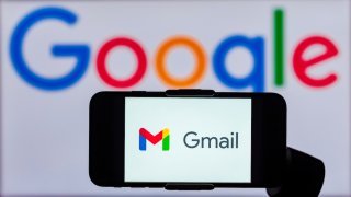 In this photo illustration, the logo of Gmail is seen displayed on a mobile phone screen with a Google logo in the background.