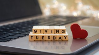 GIVING TUESDAY letter blocks concept on laptop keyboard