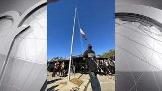 A tribal leader raises a flag honoring the Kumeyaay/Diegueño Nation to commemorate Native American Heritage Month on Nov. 28, 2023. (Cheri-Ann Inouye)